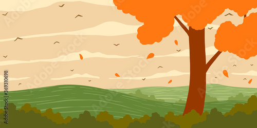Autumn. Orange deciduous tree with orange leaves on the hill.
