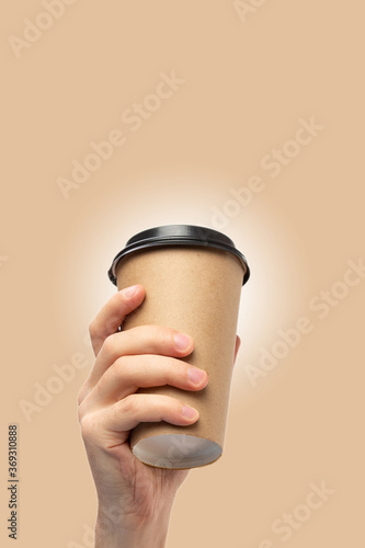 Mockup of male hand holding a Coffee paper cup. © Ivan Karpov