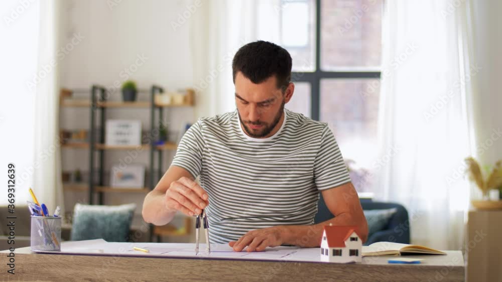 architecture, building and construction concept - male architect with blueprint and compass working at home office architecture, building and construction concept - male architect with blueprint and compass working at home office