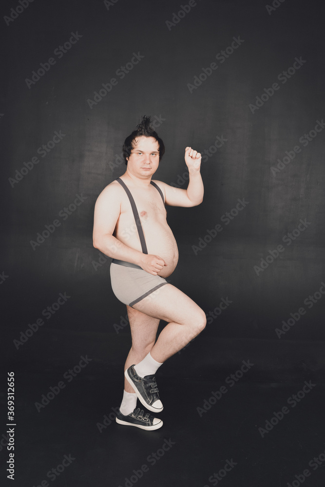 funny fat guy does physical exercises and moves in different poses funny fat guy does physical exercises and moves in different poses