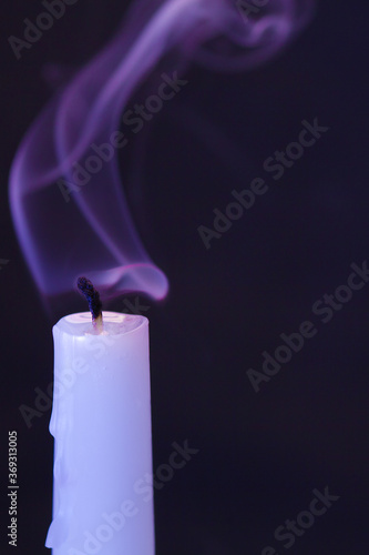Blown out white candle