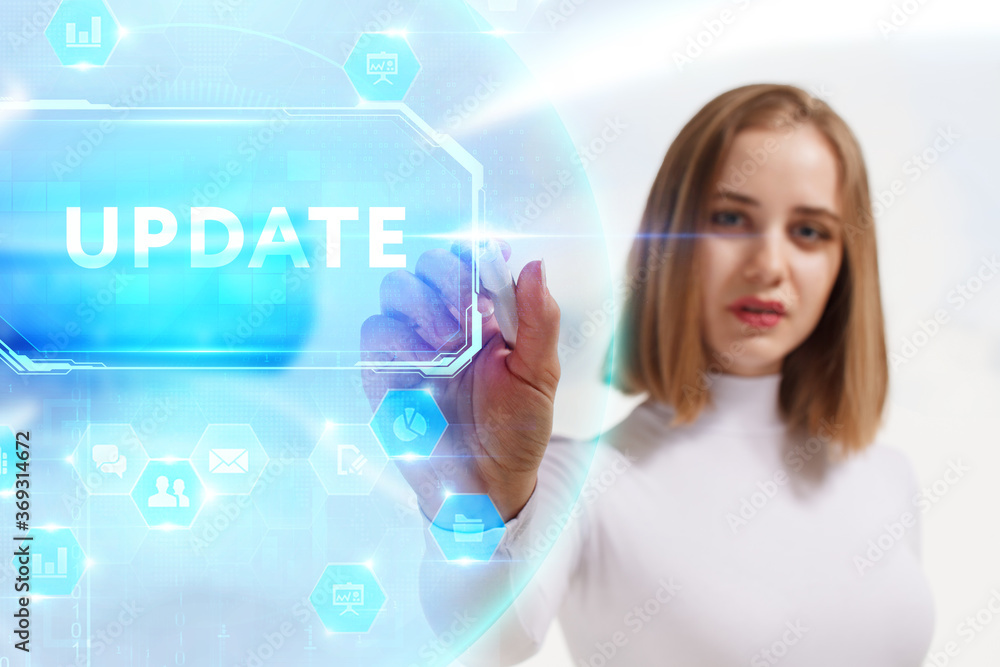 Business, Technology, Internet and network concept. Young businessman working on a virtual screen of the future and sees the inscription: Update Business, Technology, Internet and network concept. Young businessman working on a virtual screen of the future and sees the inscription: Update