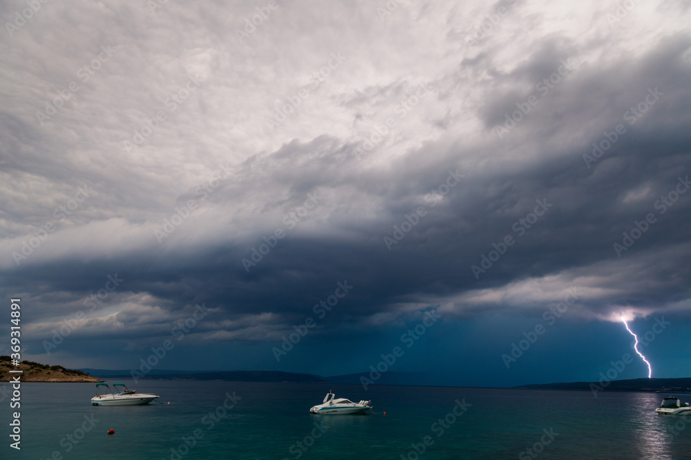 Stormy clouds with lightning on the Adriatic coast in Krk island, Croatia Stormy clouds with lightning on the Adriatic coast in Krk island, Croatia