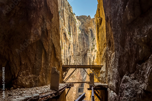 A view of an old dilapidated section of the Caminito del Rey pathway near Ardales, Spain in the summertime