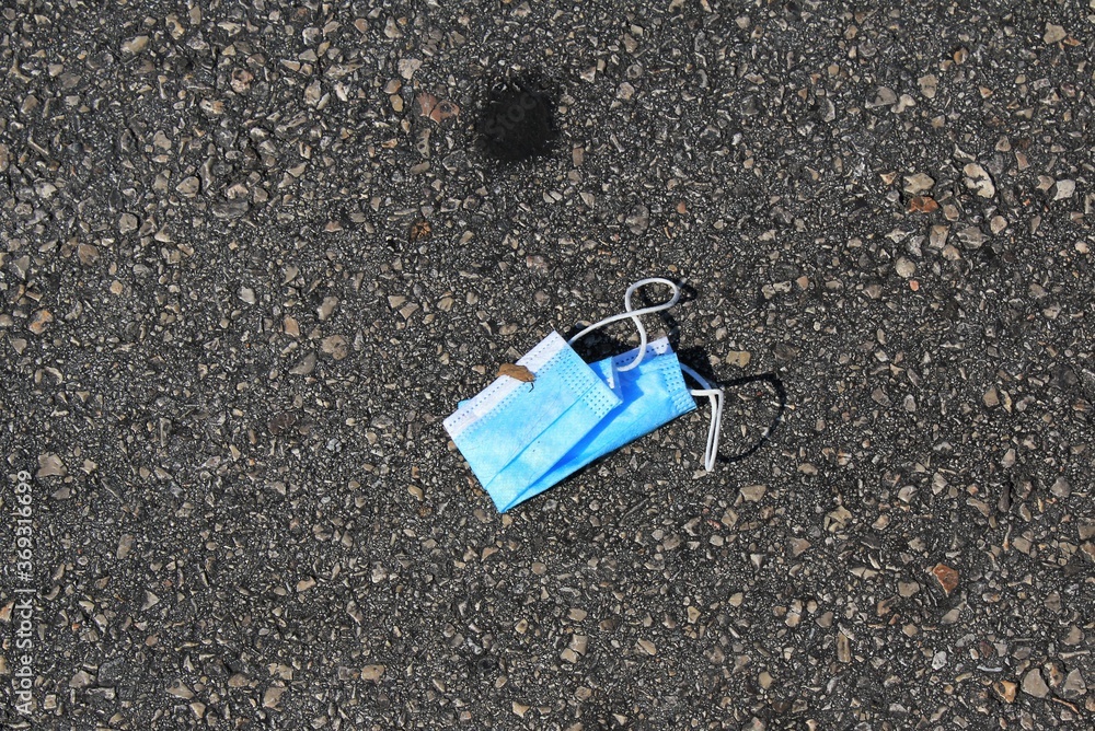 Athens, Greece,  August 1 2020 - Surgical face mask thrown on the ground at the port of Piraeus.