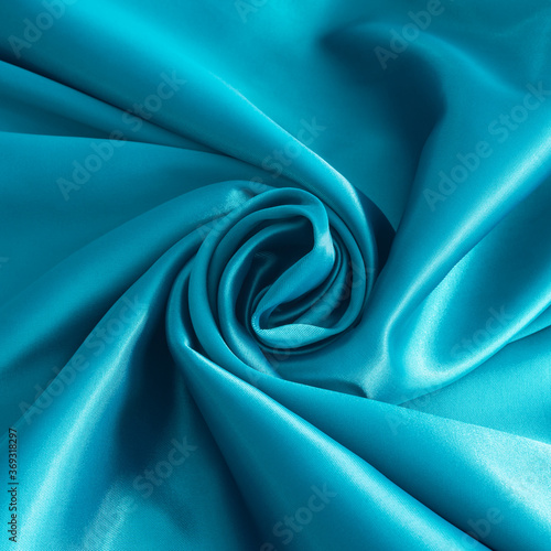 Light blue satin texture close up. Satin fabric for fashion design. Lustrous surface of satin cloth in square format
