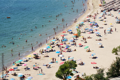 Fototapeta Naklejka Na Ścianę i Meble -  sea beach with tourists on sunny day, aerial photo