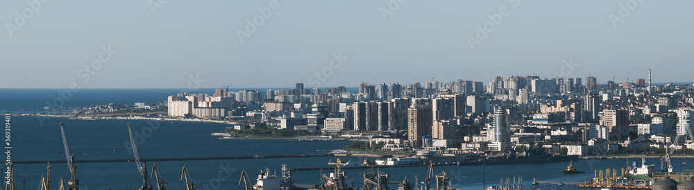 Panorama of the city of Novorossiysk. Seaport. Tanker. Cargo port. High modern houses by the sea. A clear sunny day.