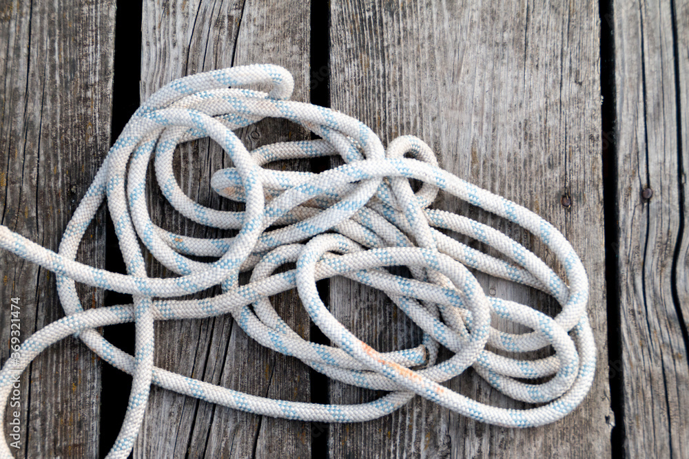 white rope on wooden deck view from above
white rope on wooden deck view from above