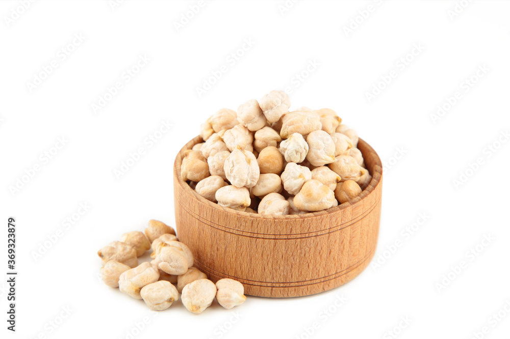 Uncooked dried chickpeas in wooden bowl isolated on white background. Vegan food concept Uncooked dried chickpeas in wooden bowl isolated on white background. Vegan food concept