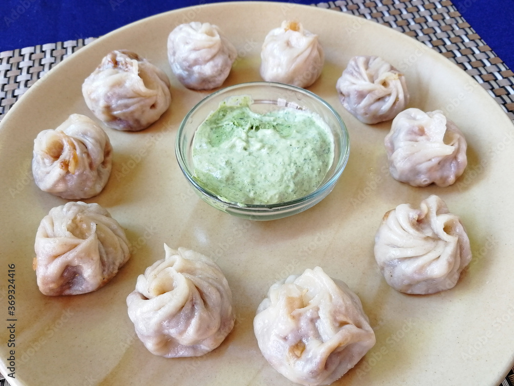 steamed Tibetan momos, the traditional dumplings with different fillings. served with sauce. Close up, side view steamed Tibetan momos, the traditional dumplings with different fillings. served with sauce. Close up, side view