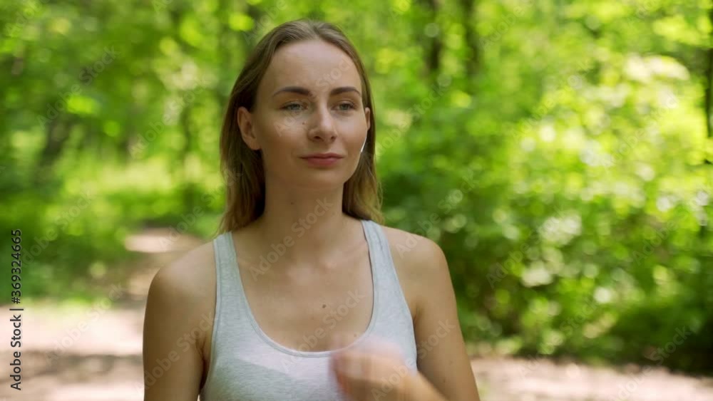 Young girl is put on earphones and runing in park in summer, healthy lifestyle. Young girl is put on earphones and runing in park in summer, healthy lifestyle.