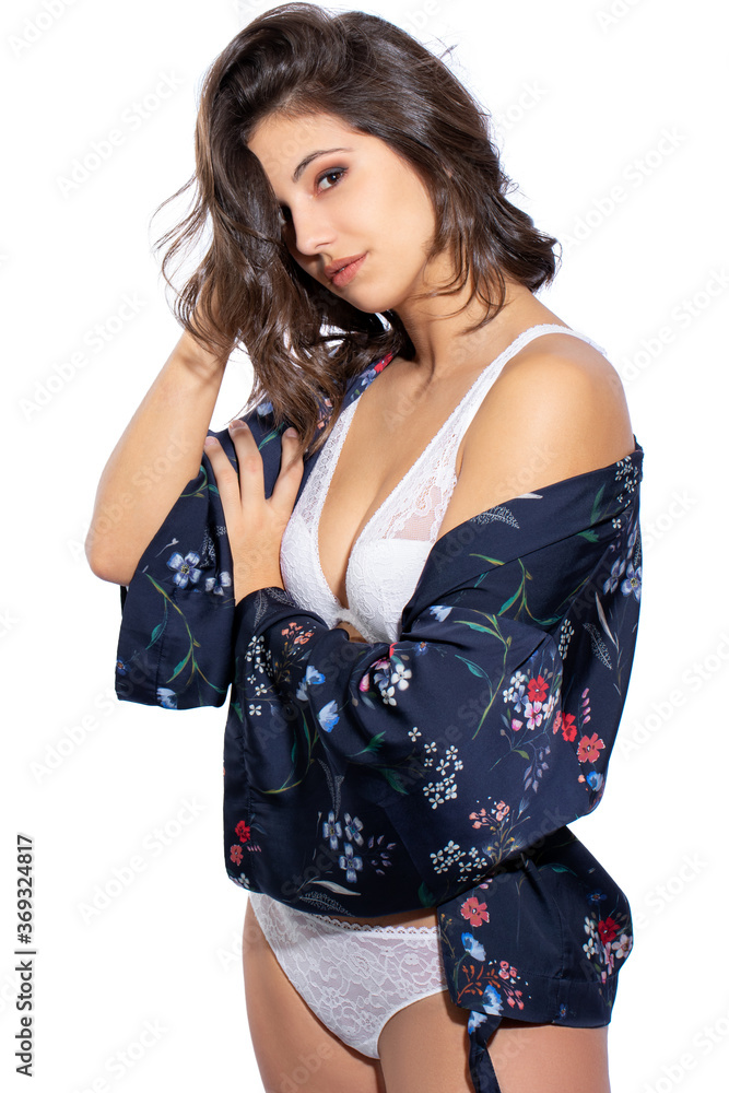 Attractive young woman wearing silk nightgown and white lingerie. Attractive young woman wearing silk nightgown and white lingerie.