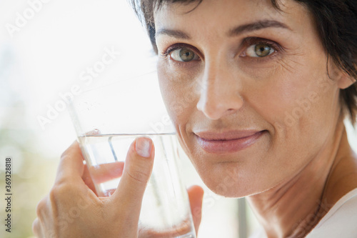 Close up portrait woman drinking water photo