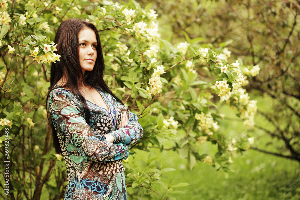 young woman in dress relaxing in garden young woman in dress relaxing in garden