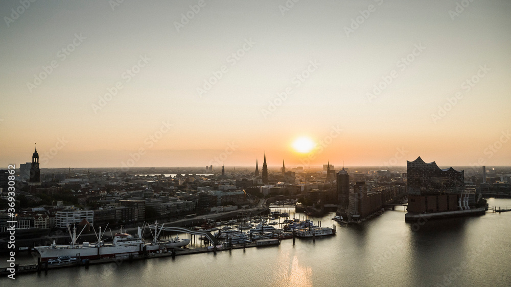 Sunset over tranquil Hamburg cityscape and Elbe River, Germany Sunset over tranquil Hamburg cityscape and Elbe River, Germany