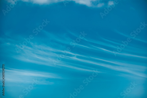 Beautiful blue sky with with light puffy cirrus clouds background © Balazs