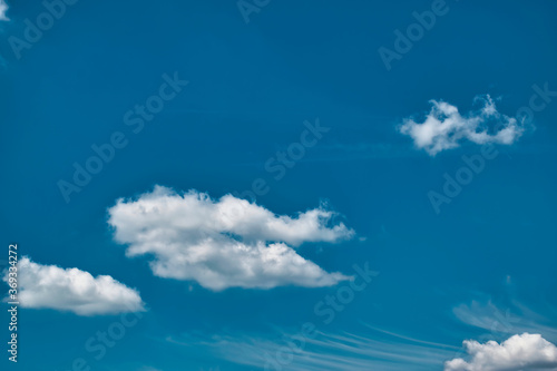 Beautiful blue sky with with light puffy cirrus clouds background