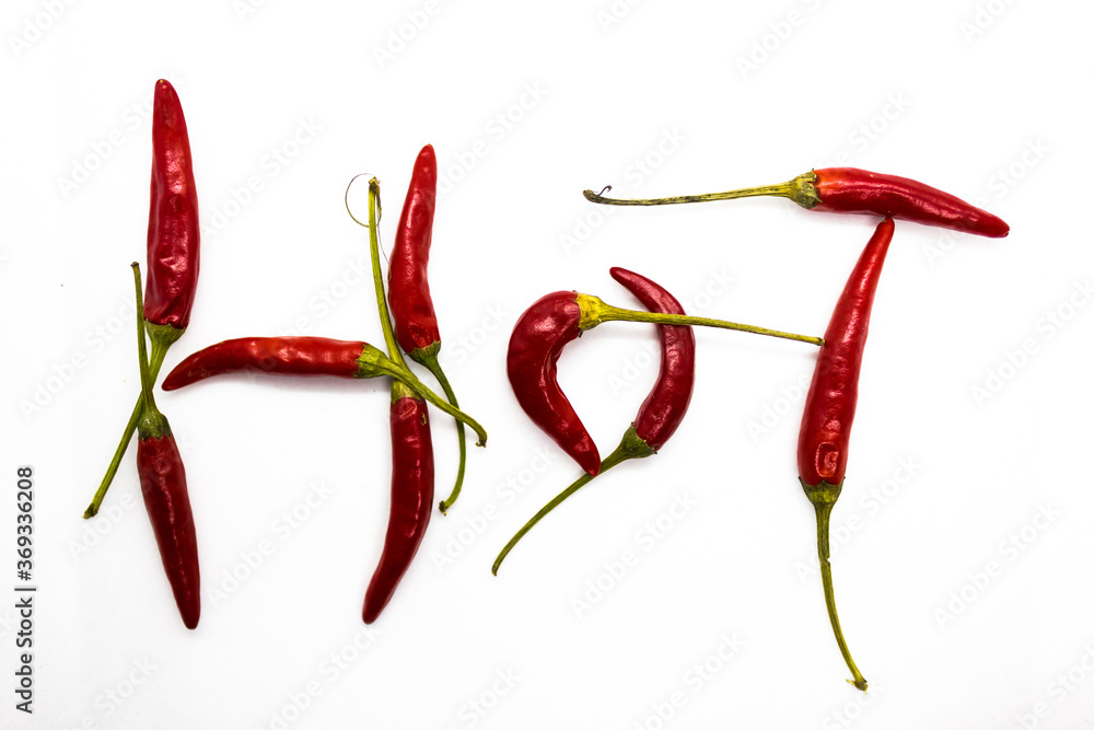 Red small chillies sticking together to form a word HOT in terms of spiciness Red small chillies sticking together to form a word HOT in terms of spiciness