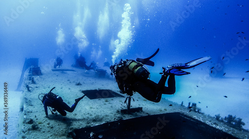 Scubadiving. Scuba divers diving at the shipwreck.