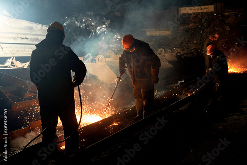 worker cuts steel