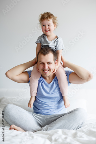 family, love and fatherhood concept - happy father having fun with his cute little girl daughter