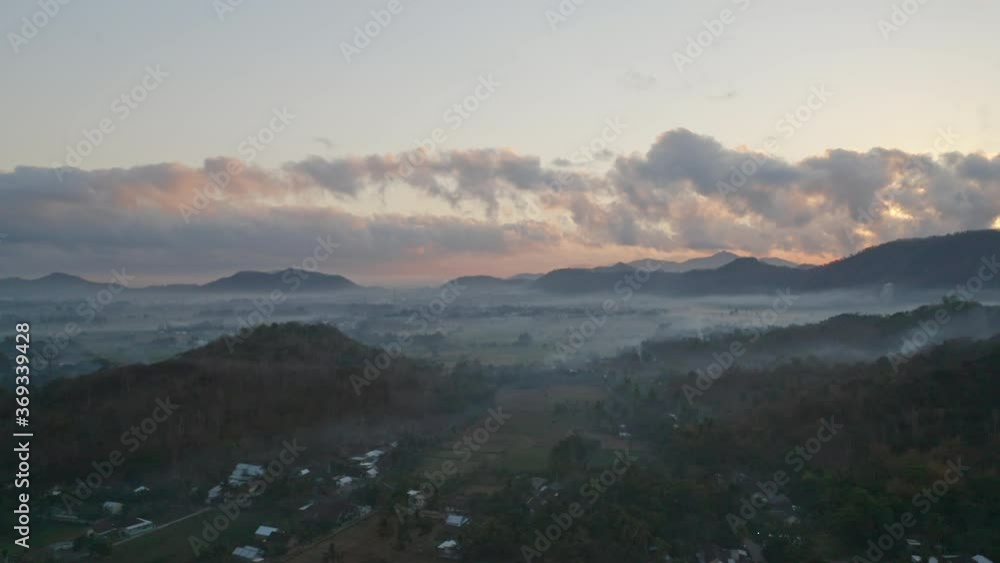 Fog Plain Fields and Mountain Silhouettes with Majestic Sky in Background Fog Plain Fields and Mountain Silhouettes with Majestic Sky in Background
