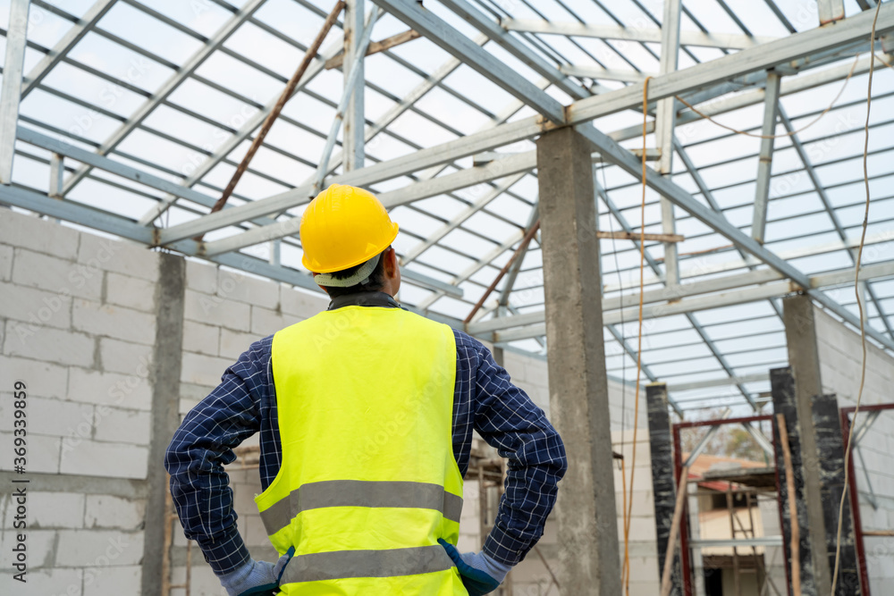 Portrait of construction worker on building site,Construction worker with hard hat working in new house. Portrait of construction worker on building site,Construction worker with hard hat working in new house.