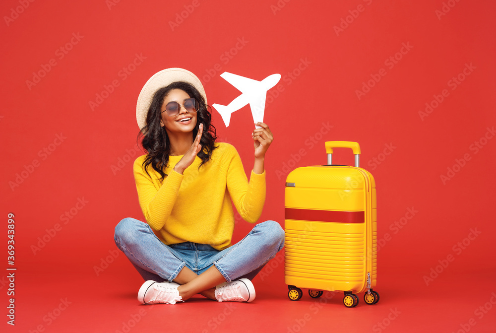 Ethnic traveler playing with toy plane. Ethnic traveler playing with toy plane.