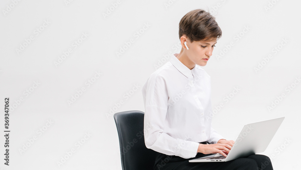 Portrait of a businesswoman using laptop on the office chair isolated on a white background Portrait of a businesswoman using laptop on the office chair isolated on a white background