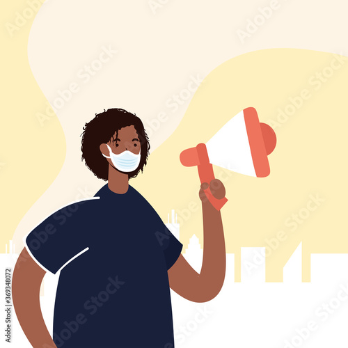 afro man wearing medical mask protesting with megaphone