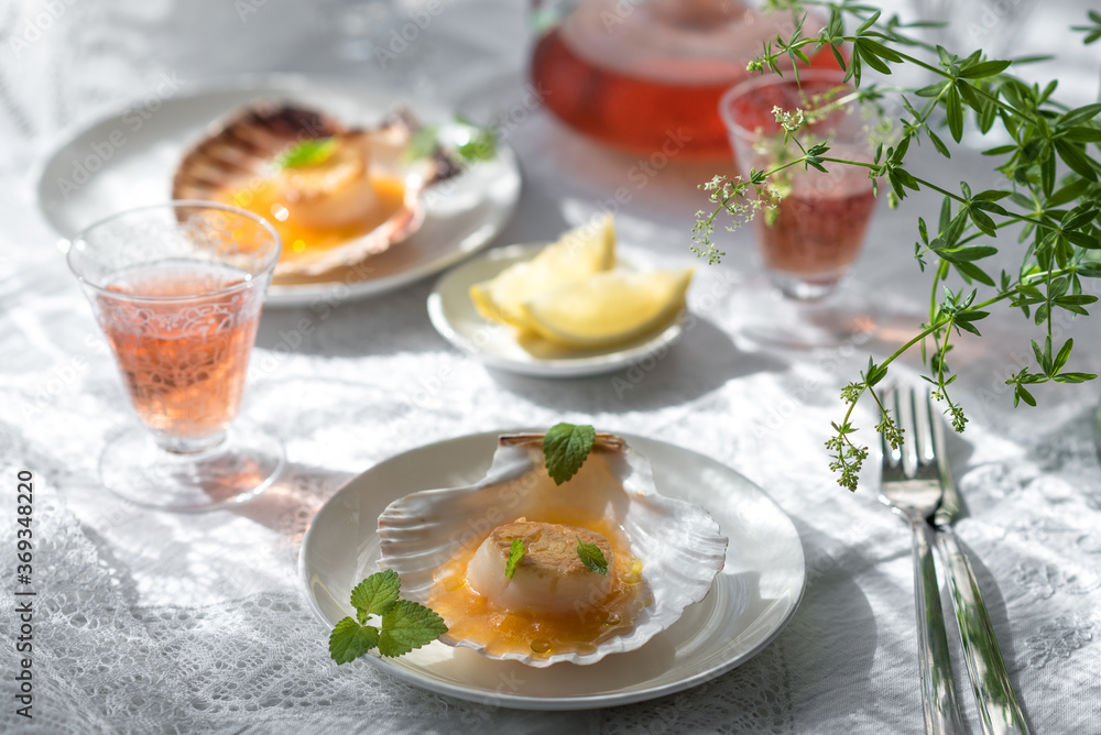 Pan Seared Sea Scallops with Orange Tomato Sauce. Glass of Rose Wine Pan Seared Sea Scallops with Orange Tomato Sauce. Glass of Rose Wine