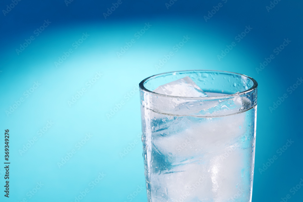 fresh ice water glass close up over blue background. copy space. ice drink at summer season. refreshment beverage. healthy lifestyle concept fresh ice water glass close up over blue background. copy space. ice drink at summer season. refreshment beverage. healthy lifestyle concept