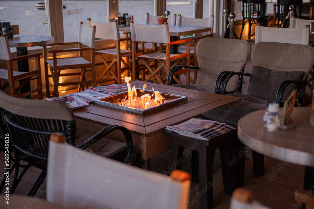 fire on the table in a cozy cafe in pastel colors