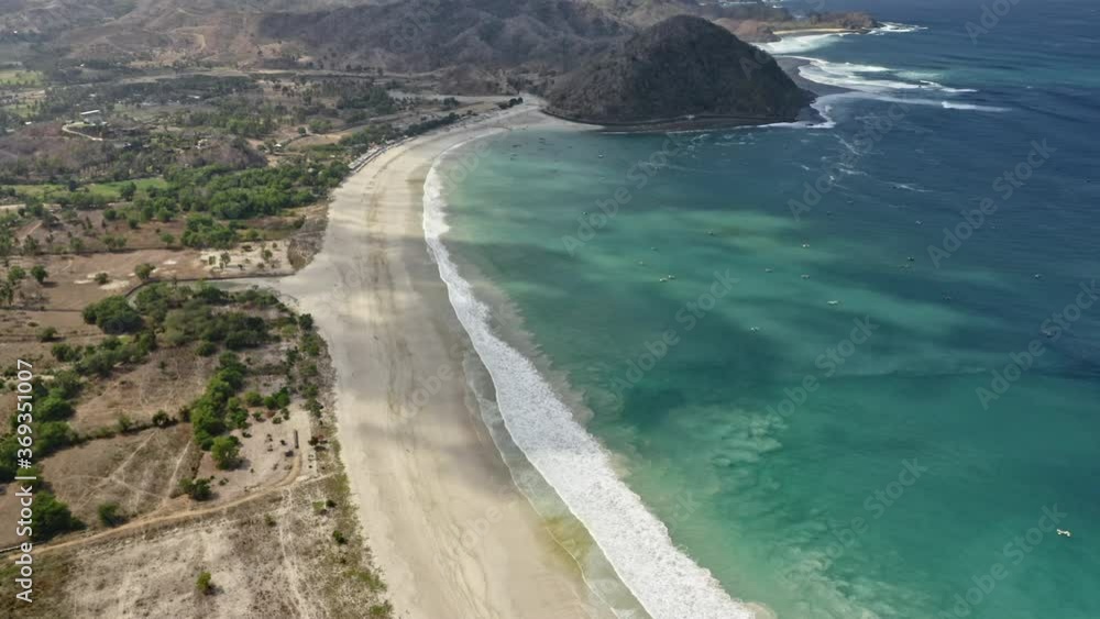 Scenic Aerial View of Sandy Coast and Waves Forming White Foam in Indonesia