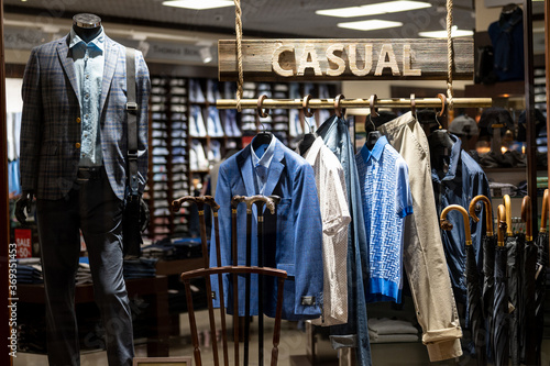 Dummies in casual men clothes in showcase with inscription 'Casual clothes'