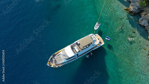 Aerial drone photo of large yacht - boat anchored in tropical exotic paradise bay with emerald open ocean