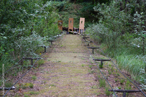 Shooting range in a summer forest under the open sky with targets in the background