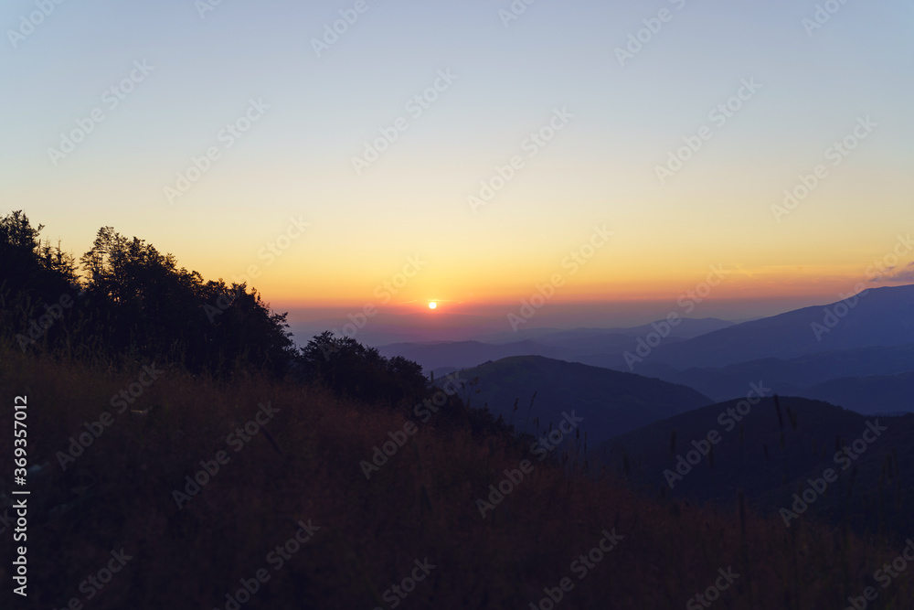 Mountain landscape in sunrise or sunset - Foggy image of hills covered with forest and sky - freedom nature tourist destination concept - stara planina Old Mountain in Serbia