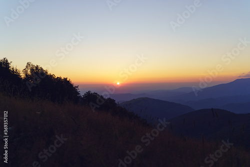 Mountain landscape in sunrise or sunset - Foggy image of hills covered with forest and sky - freedom nature tourist destination concept - stara planina Old Mountain in Serbia © Miljan Živković