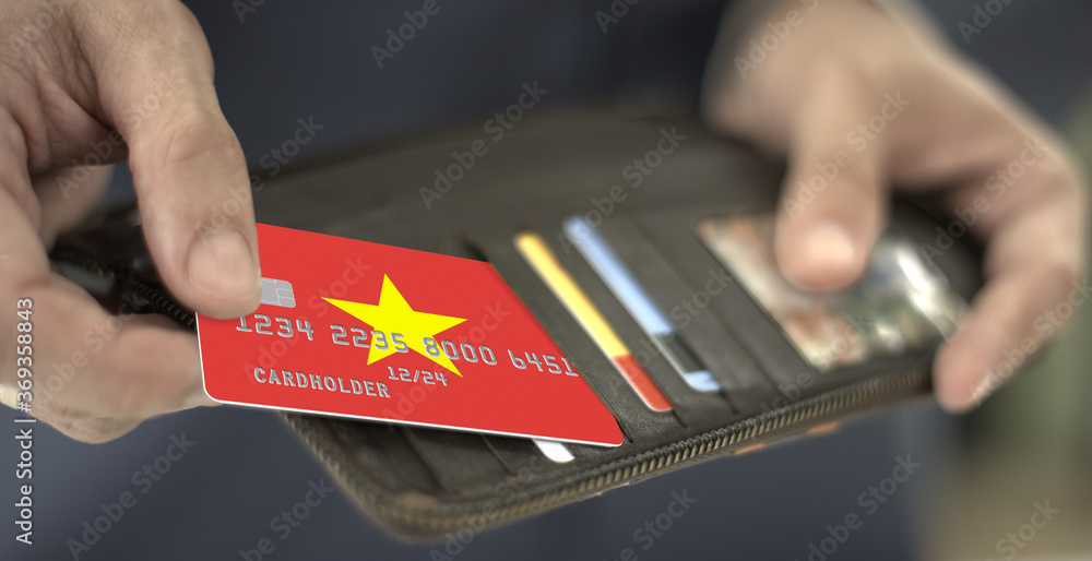Man pulls plastic bank card with flag of Vietnam out of his wallet, fictional card number