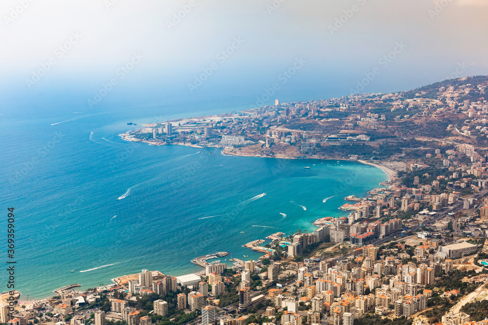 Aerial view of the Jounieh coastal city, Lebanon. Panoramic view of the seaside resorts, turquoise sea water, boats, paragliders, buildings