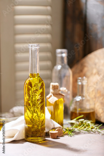 Olive oil with rosemary in glass bottles