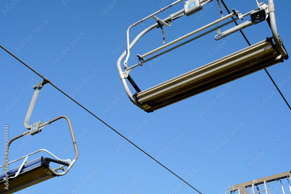 Old Mountain, Serbia, July 28, 2020, Empty ski lift chairs sitting idle during the summer. Waiting for snow. Old Mountain, Serbia, July 28, 2020, Empty ski lift chairs sitting idle during the summer. Waiting for snow.