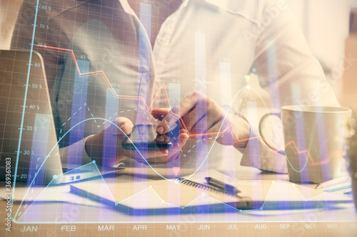 Double exposure of forex chart sketch hologram and woman holding and using a mobile device. Financial market concept.