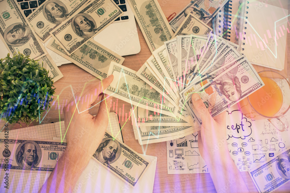 Multi exposure of financial graph drawing hologram and USA dollars bills and man hands. Analysis concept. Multi exposure of financial graph drawing hologram and USA dollars bills and man hands. Analysis concept.