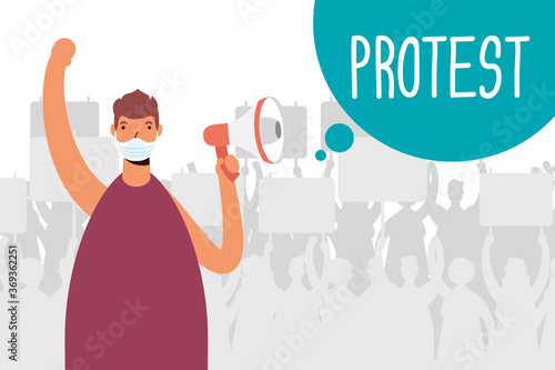 man wearing medical mask protesting with megaphone
