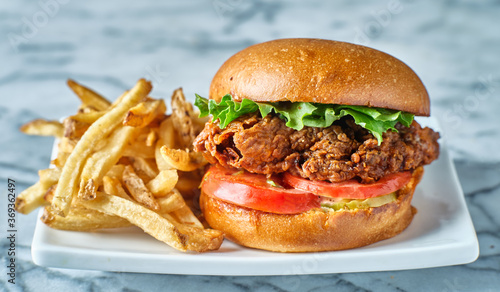 crispy fried chicken sandwich on brioche bun with french fries