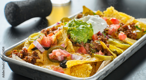Canvas Print tray of loaded mexican nachos with beef and queso cheese