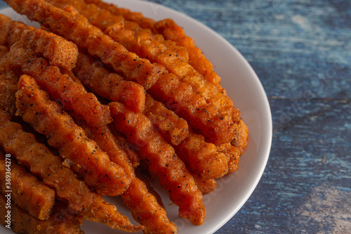 Plate of Sweet Potatoe Fries on a Blue Wooden Table